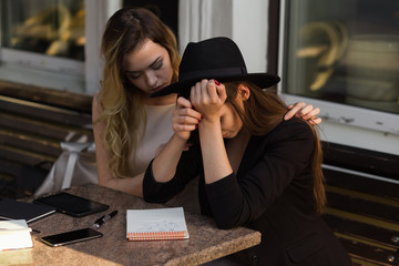 A friend calms a distressed friend because of a recent setback.