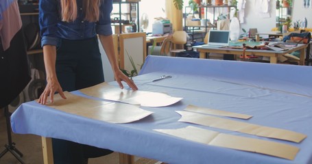 Young woman cutting fabric