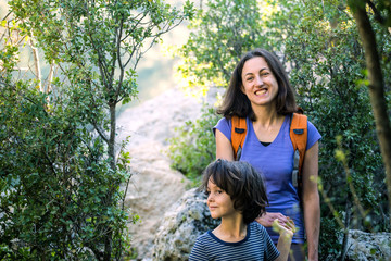 A child with his mother go hiking.