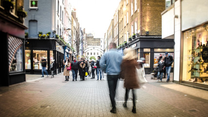 Naklejka na ściany i meble Motion blurred high street shoppers