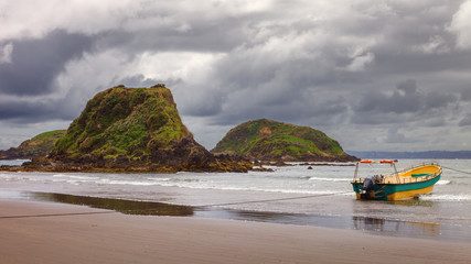 Moored boat used to take tourists to see penguins in the protected area of the Punihuil islets in the island of Chiloé, Chile