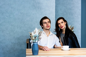 Couple drinking coffee laughing in cafe