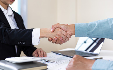 Financial accountants and marketers shaking hand to congratulate the double-digit real estate performance, Meetings and hand shake concept.