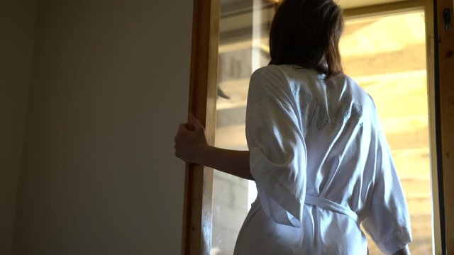 Self isolation. Social distancing and woman. Sad girl by the window. Bride upset looking through the window. Depression and loneliness.
