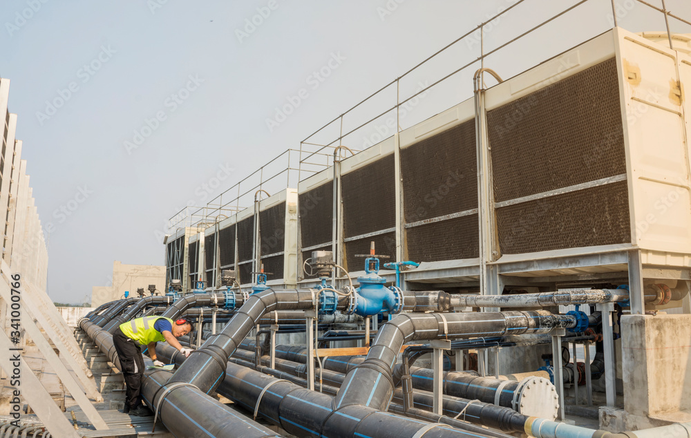 Wall mural engineers inspect machine operations. cooling towers in large buildings for safety