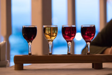 set of four glasses with drinks of different colors, vodka, cognac, alcohol, spirits