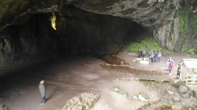 Aerial footage of Smoo Caves near Dunnet and John O'groats Scotland. Capturing a shot from inside the cave panning back to reveal its scale as it undercuts the Scottish coastline. Taken during NC500.