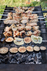 Pork meat and chopped vegetables are grilled on hot coals