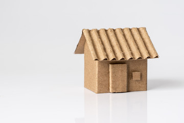 Model of cardboard house isolated on white background for building, mortgage, real estate or buying a new home concept.