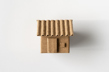 Model of cardboard house isolated on white background for building, mortgage, real estate or buying a new home concept. Lay flat view.