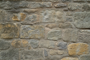 Natural stone wall texture. Medieval masonry. Ancient wall. Stone brick wall. Macro texture. Medieval architecture. Rough masonry. Background texture.