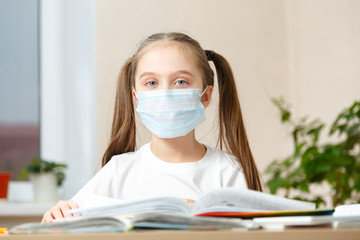 Little Girl in a Protective Mask at Distance Home Schooling, Quarantine