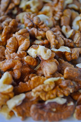Walnuts on a white wooden background.