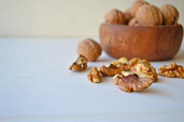 Walnuts on a white wooden background.