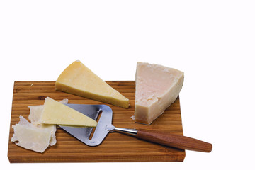  View of different kinds of cheese with cheese knife isolated on wooden board. Healthy food concept.