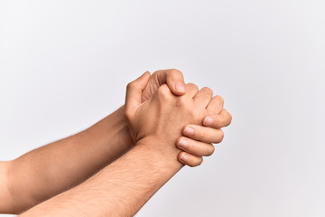 Hand of caucasian young man showing fingers over isolated white background with both hands crossed together showing strength and confidence