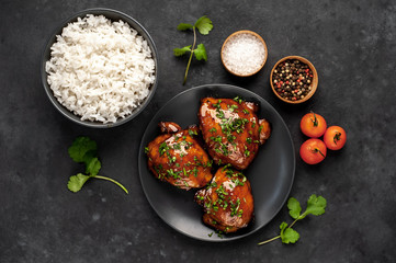 grilled sweet chicken thighs and  cooked rice on a stone background. Asian food