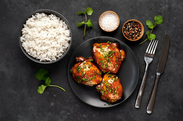 grilled sweet chicken thighs and  cooked rice on a stone background. Asian food