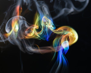 Rainbow colored smoke on a black background