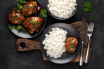 grilled sweet chicken thighs and  cooked rice on a stone background. Asian food