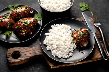 grilled sweet chicken thighs and  cooked rice on a stone background. Asian food