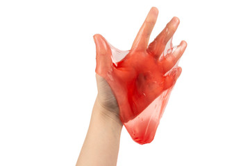 Red slime toy in woman hand isolated on white.