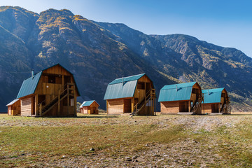 Wooden guest houses in a tourist camp in a mountain valley. Russia, the Republic of Altai, tract Akkurum