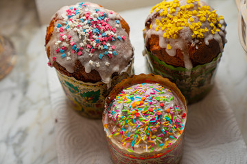 Three Easter cakes on a white napkin background.