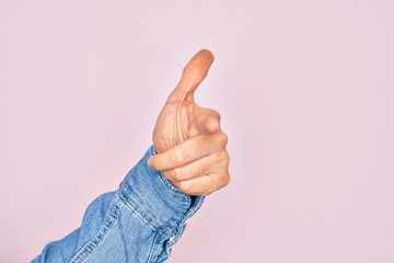 Hand of caucasian young man showing fingers over isolated pink background pointing forefinger to the camera, choosing and indicating towards direction