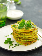 Fritters from zucchini and greens with poached egg. Healthy breakfast. Selective focus