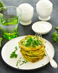 Fritters from zucchini and greens with poached egg. Healthy breakfast. Selective focus