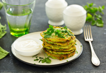 Fritters from zucchini and greens with poached egg. Healthy breakfast. Selective focus