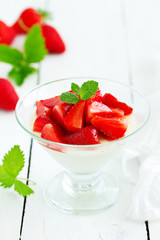 Panna cotta with strawberry sauce and mint.
