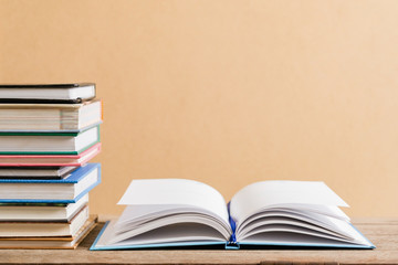 Books and textbook on wooden desk in library, Piles of books on reading desk in school with copy space for text.World book day and education concept.