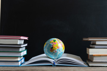 Books and textbook on wooden desk in library, Piles of books on reading desk in school with copy...