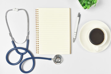 Medical mock-up with blank sheet of paper, clipboard, stethoscope, glasses, heart on doctor desk. Healthcare and medical concept.