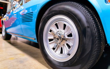 Fototapeta na wymiar Wheel of blue vintage classic car auto reflex