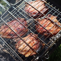 Pork steaks cooked on a charcoal grill outdoors