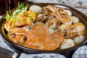 Stewed pork chop in a bright mushroom sauce.
