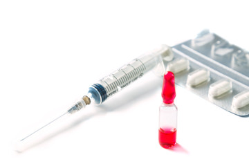 Close-up macro shot of glass ampoules with vaccine or cure for SARS covid-19 virus on a white...