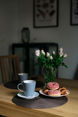 Croissants, flowers, and morning coffee in the kitchen