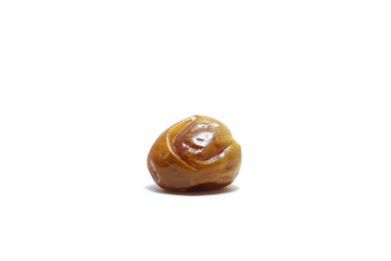 A piece of sukkari dates (kurma sukari) isolated on white background, perfect for breakfasting during ramadan