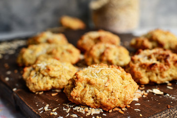 Oatmeal cookies on a wooden background. Close-up. Free space for the test. Healthy homemade cookies. Sweet pastries. Coconut flakes