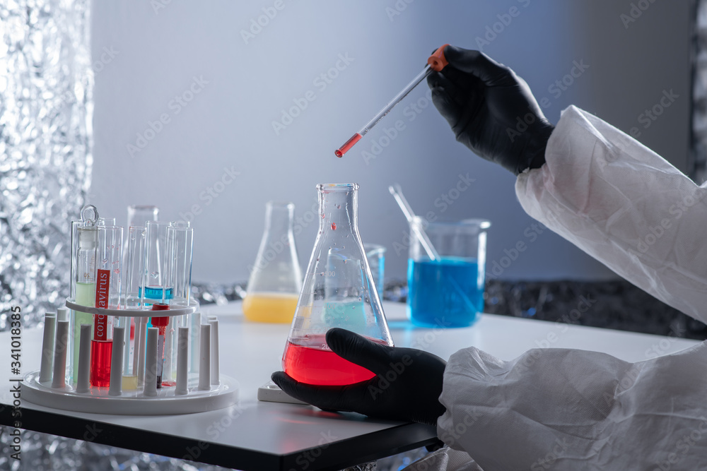 Wall mural a close-up portrait of a chemist wearing protective gloves, holding a flask of red liquid. scientist