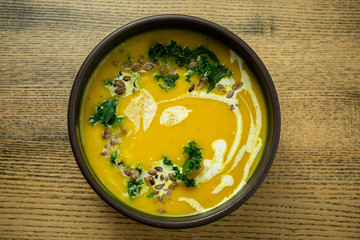 Pumpkin and kale cream soup with sweet cream