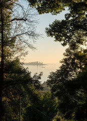 View of the city of Batumi on the Black Sea. Small mountains covered with forest. Panorama, view from the forest of the Botanical Garden. Evening. Cloudy. Georgia.