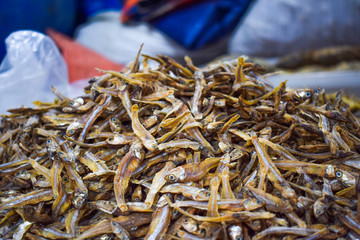 Heap of lot of dry fishes stacked together to sell in the dry fish market