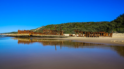 Obraz premium Colourful Maheno Wreck view from low tide on Fraser Island, Queensland, Australia