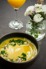 Pumpkin and kale cream soup with sweet cream