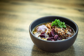 Bean soup with smoked pork, potatoes, herbs, onion